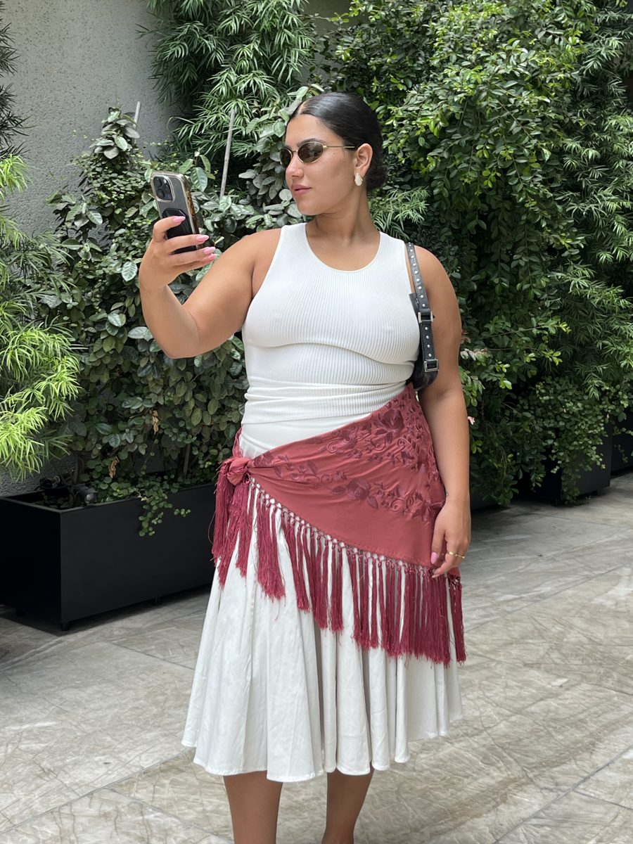 A SLIMZ customer in a white SLIMZ top with a fringed skirt